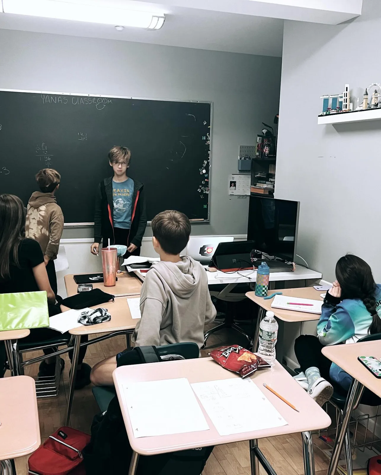 A student working at the chalkboard at Math Corner Tutoring