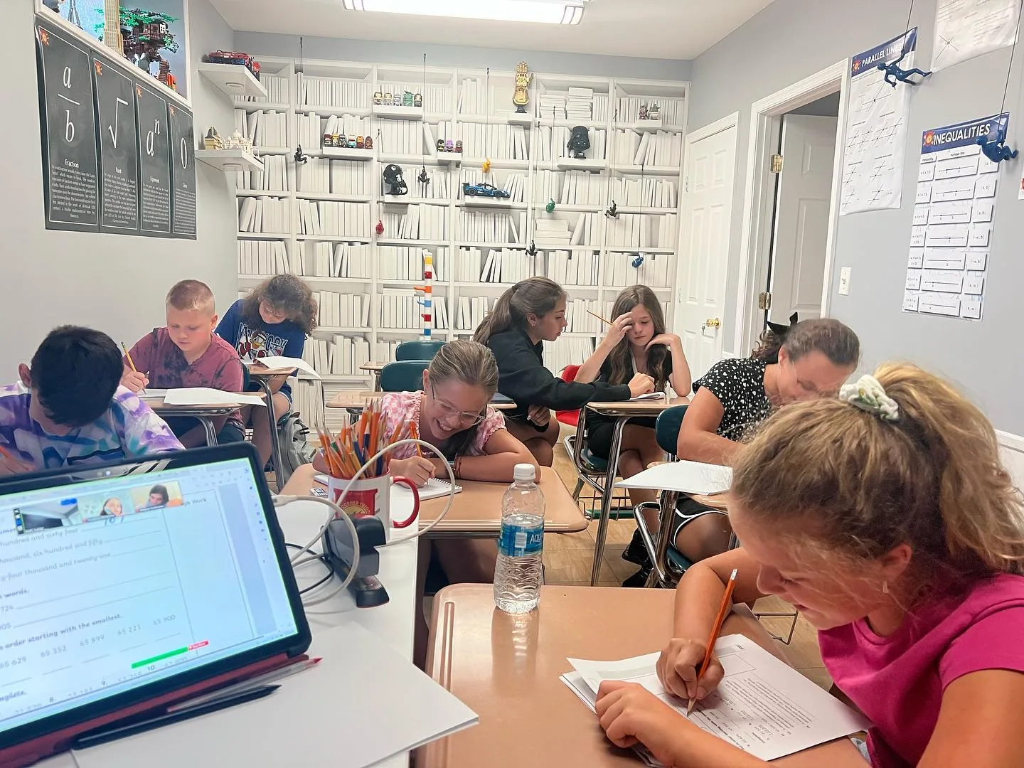 Students writing at their desks in the Math Corner classroom